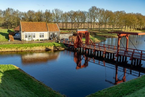 Moat and drawbridge of the inhabited former Bourtange fortress, Groningen, Netherlands