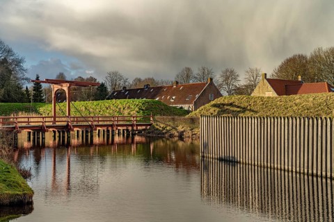 Moat and drawbridge of the inhabited former Bourtange fortress, Groningen, Netherlands