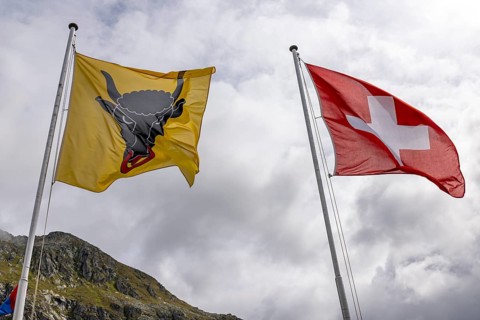 Swiss and Uri flag, blowing in the wind, Gotthard Pass, Gottardo, Ticino, Switzerland