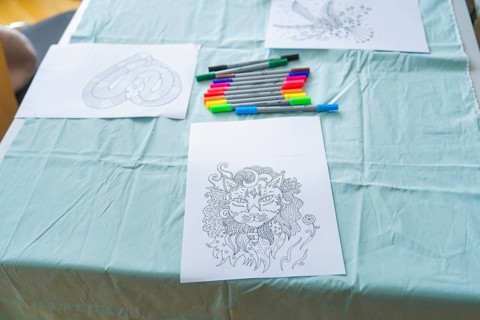 Cat mandala drawing with coloured markers on a table in an office-like environment, Youth Research