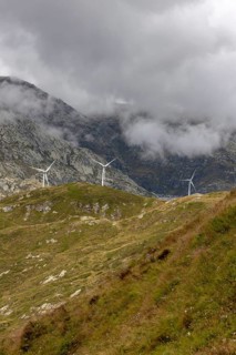 Wind turbines on the Gotthard Pass in the clouds, view from Passo Scimfuss, Airolo, Ticino,