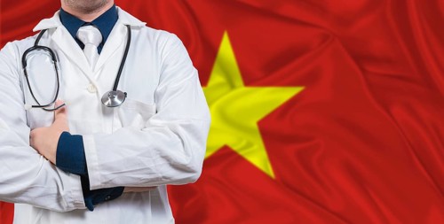Male doctor with stethoscope on Vietnam flag. Doctor holding stethoscope on Vietnam flag