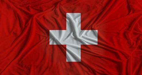 Swiss flag with fabric texture background. National flag of Switzerland