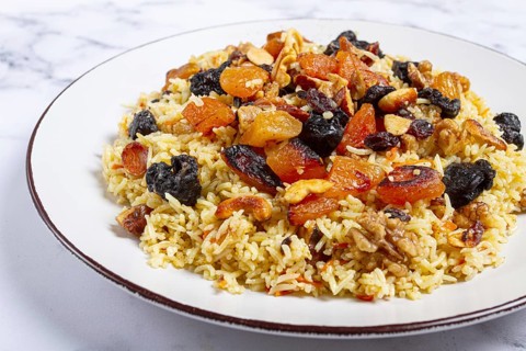 Rice dish, with the addition of dried fruits, nuts and spices of Middle Eastern cuisine, homemade,