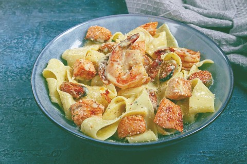 Papardelle pasta in creamy sauce with seafood, homemade, no people