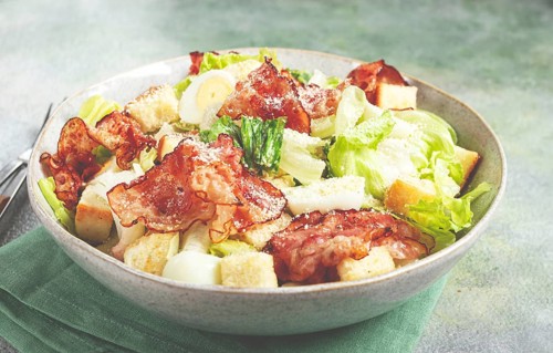 Caesar salad with fried bacon, quail eggs, homemade, no people