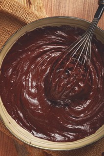 A bowl of chocolate dough, a whisk for whipping, baking, structure and consistency, homemade, top
