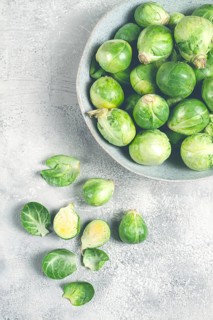 Fresh Brussels sprouts, raw, top view, on a gray table, no people