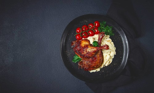 Fried duck shank, cauliflower puree, cherry tomatoes, homemade, no people