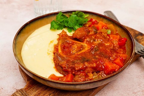Ossobuco, stewed meat knuckle on the bone, with mashed potatoes, and oats and spices, homemade, no