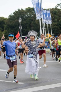 A runner with the flag of the People's Republic of China on the Great Star at the 51st BMW Berlin