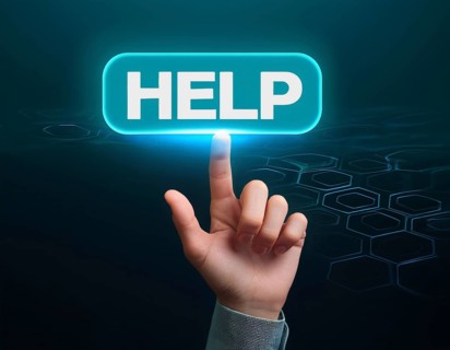 Hand point at an illuminated 'Help' button against a dark background with digital hexagonal
