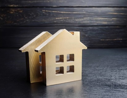 A collection of small model houses with cozy lighting, creating a warm and inviting atmosphere, AI