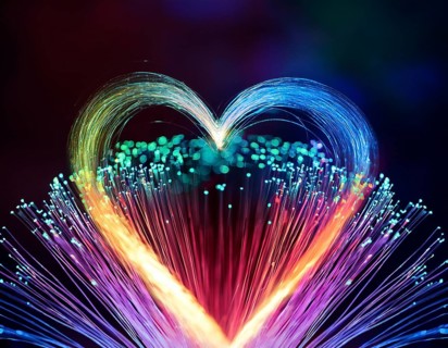 Colorful artistic display featuring vibrant light patterns shaped like a heart, expressing love and