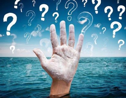 An extended hand emerges from water surrounded by floating question marks, artistically