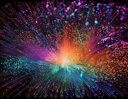 Vibrant and energetic multicolored powder explosion captured against a dark background. Evoking