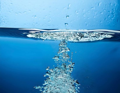 High-quality image showing a splash of water pouring into a clean surface, symbolizing freshness,