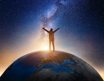 A man stands victoriously atop the Earth amidst a surreal cloudscape, symbolizing triumph over