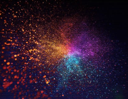 Vibrant and energetic multicolored powder explosion captured against a dark background. Evoking