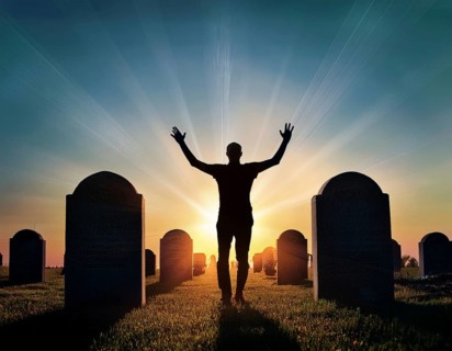 A silhouette of a lone figure walking off a gravestone, The scene evokes Resurrection thoughts