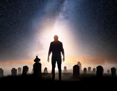 A silhouette of a lone figure walking off a gravestone, The scene evokes Resurrection thoughts