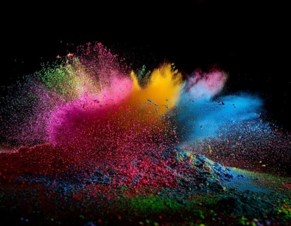 A colorful explosion powder on black background.. Multicolored powder explosion, AI generated