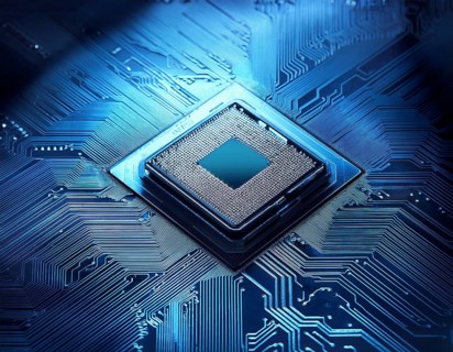 A close-up view of a glowing central processing unit on a bluish circuit board, representing