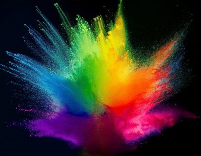 Colorful abstract art depicting a vibrant explosion of rainbow hues on a dark background, evoking