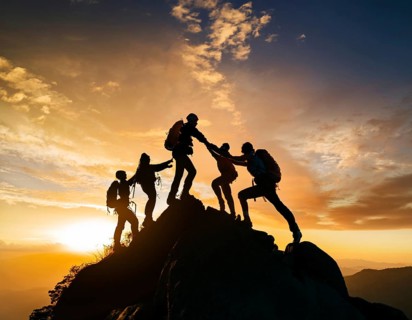 A dynamic depiction of teamwork and determination, climbers ascend a rugged mountain peak during