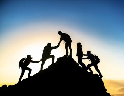 A dynamic depiction of teamwork and determination, climbers ascend a rugged mountain peak during