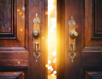 Vintage door ajar in the middle with glowing magical warm lights on the other side, AI generated