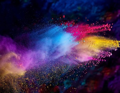A colorful explosion powder on black background.. Multicolored powder explosion, AI generated