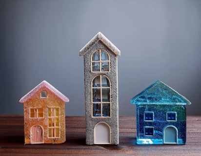 A collection of small glass model houses with cozy lighting, creating a warm and inviting