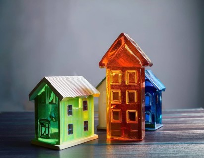 A collection of small glass model houses with cozy lighting, creating a warm and inviting