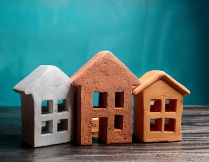 A collection of small model houses with cozy lighting, creating a warm and inviting atmosphere, AI