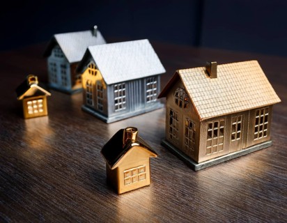 A collection of small model houses with cozy lighting, creating a warm and inviting atmosphere, AI