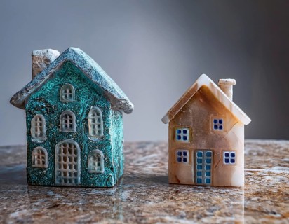 A collection of small model houses with cozy lighting, creating a warm and inviting atmosphere, AI