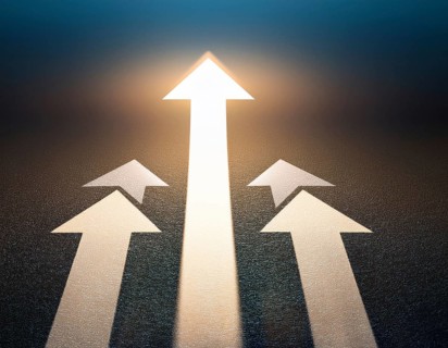 A bold blue arrow pointing upward, surrounded by four silver arrows. Represents leadership,