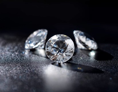 A brilliant collection of diamonds illuminated with striking lighting effects, emphasizing their