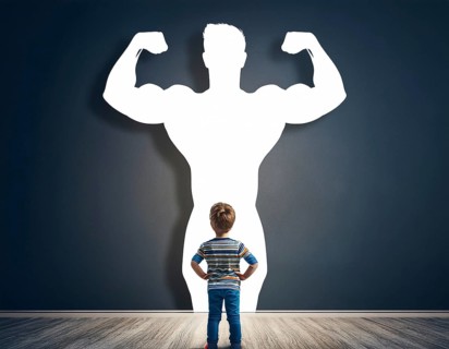 A young boy gazes at his shadow, transformed into a superhero, symbolizing imagination, dreams, and