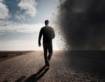 Creative image showing a silhouette of a man merging with an abstract dispersion effect and