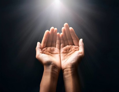 Individual Worship at Home. Image of open hands embracing a radiant light source, embodying