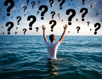 An extended hand emerges from water surrounded by floating question marks, artistically
