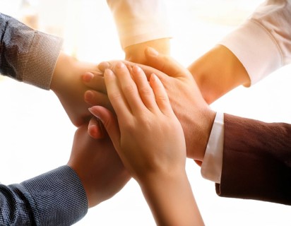 Showcasing hands stacked together in harmony, symbolizing unity, cooperation, teamwork, and