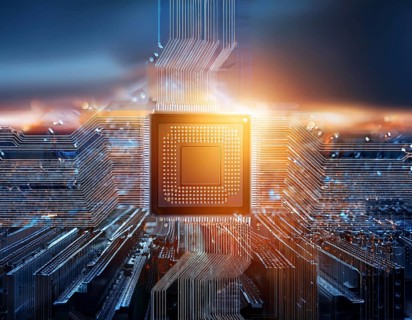 A close-up view of a glowing central processing unit on a bluish circuit board, representing