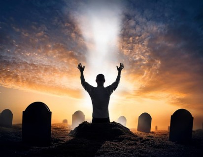 A silhouette of a lone figure walking off a gravestone, The scene evokes Resurrection thoughts