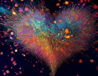 Colorful light particles form a radiant and dynamic heart shape against a dark background,