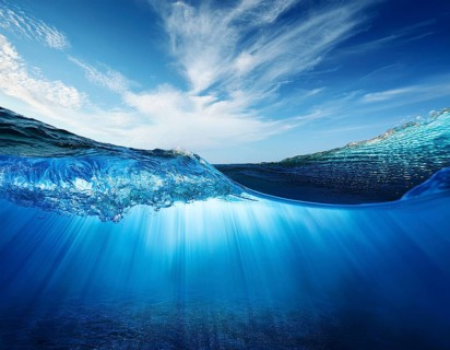 Water wave under blue sky. . Water wave with bubbles, AI generated