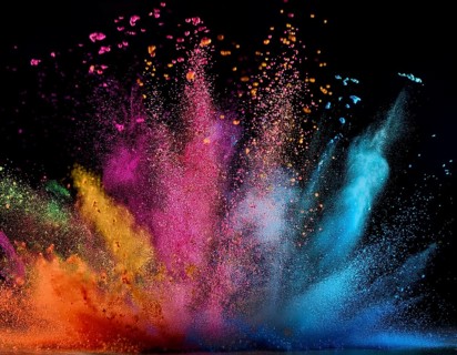 A colorful explosion powder on black background.. Multicolored powder explosion, AI generated