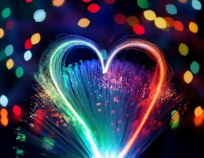 Colorful artistic display featuring vibrant light patterns shaped like a heart, expressing love and